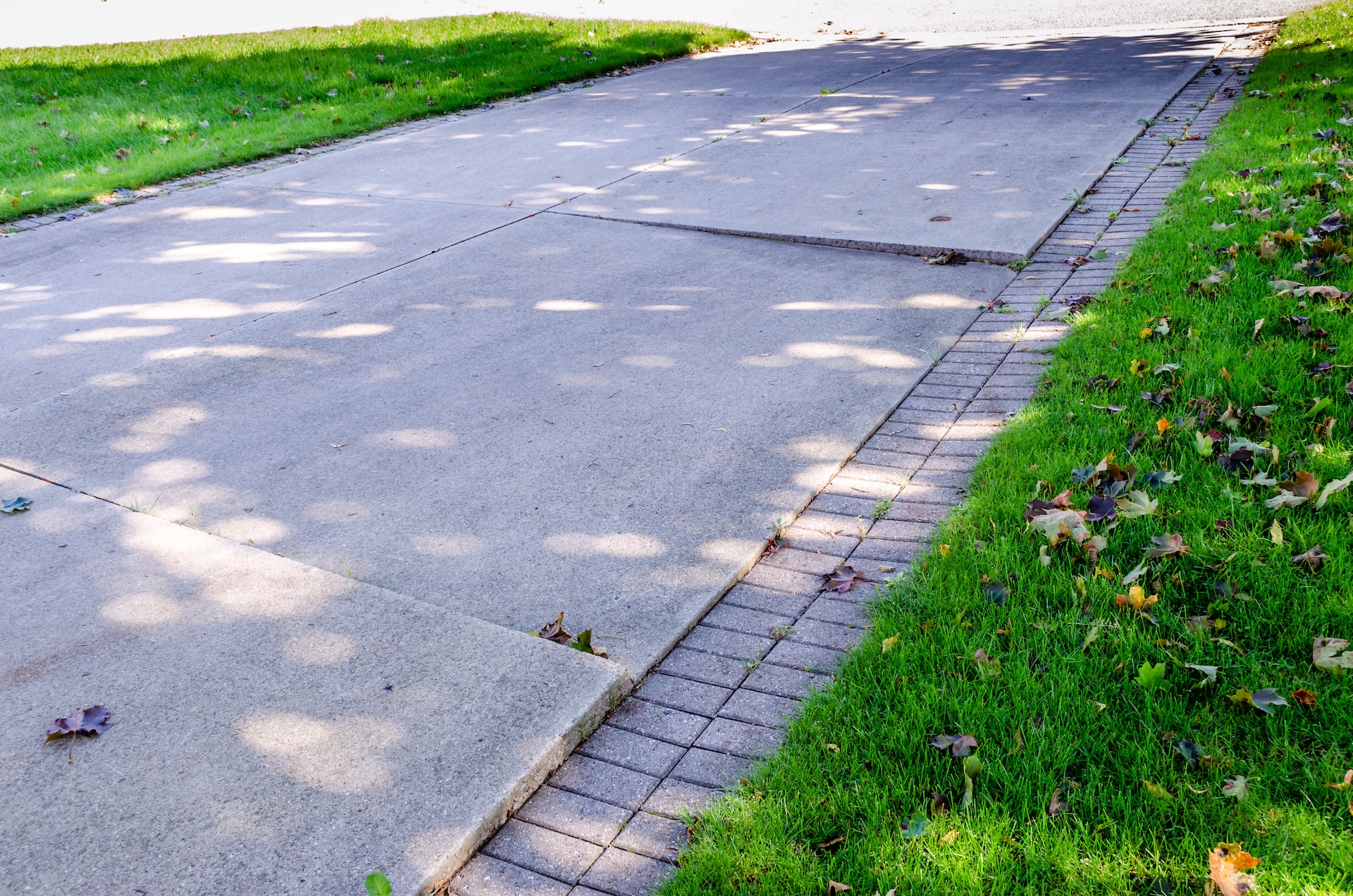 Sunken driveway with separated concrete slabs, Imperial Foundation Repair job site in North Texas