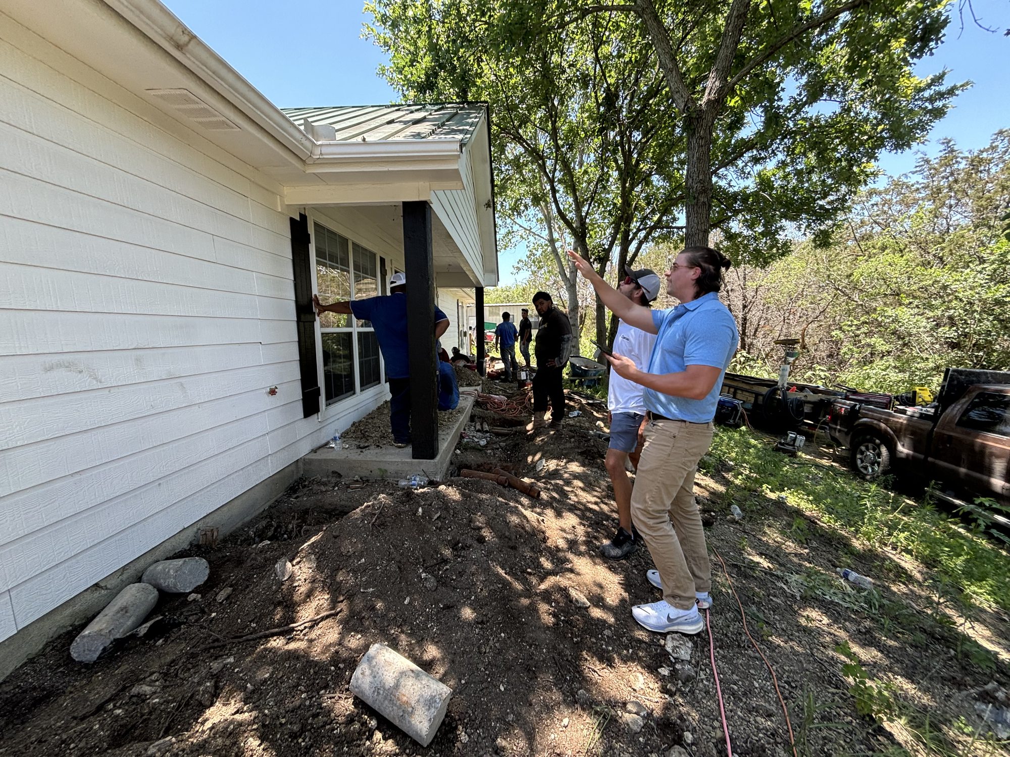 Rep inspecting exterior, Imperial Foundation Repair job site in North Texas