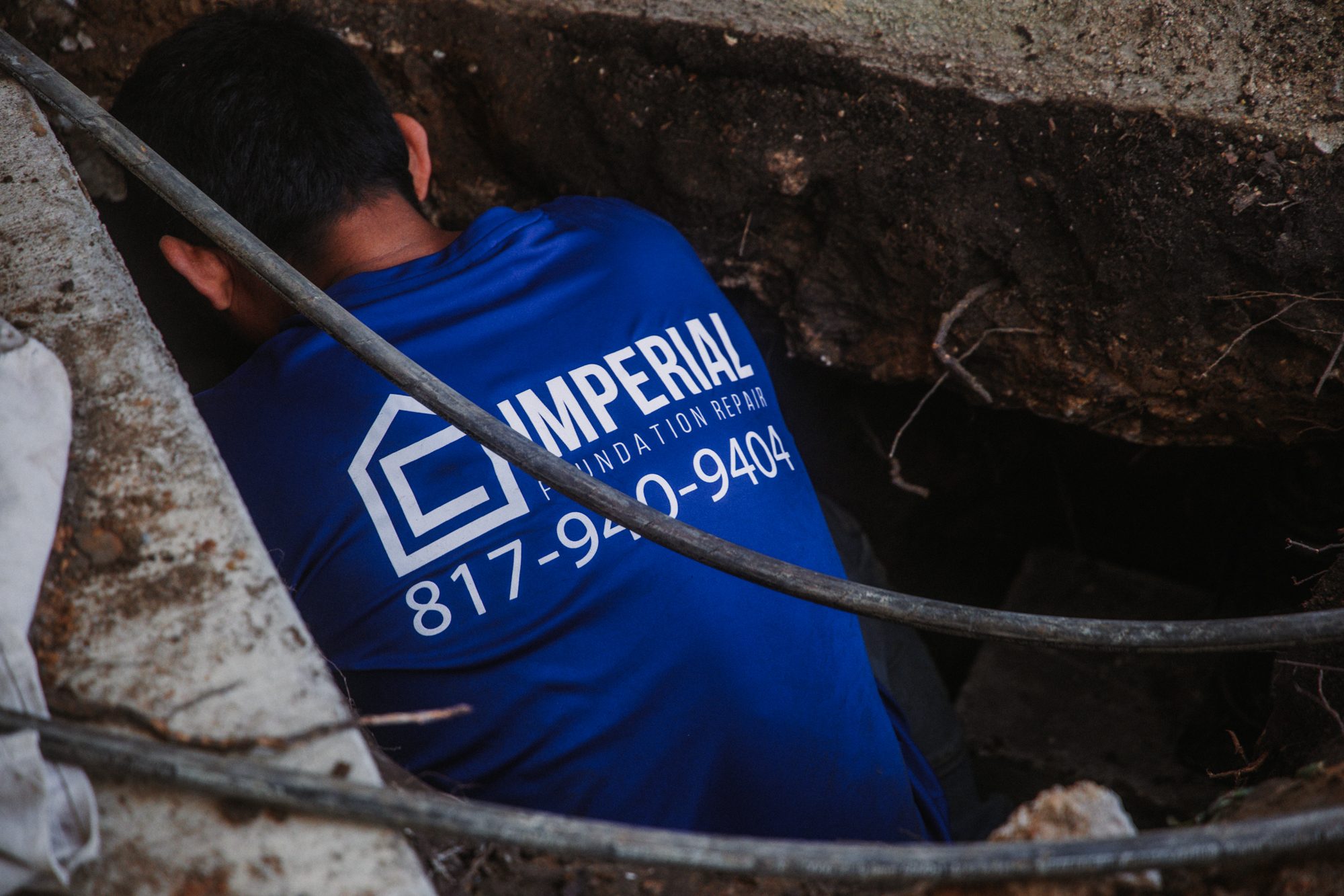 Tunnel worker branded, Imperial Foundation Repair job site in North Texas