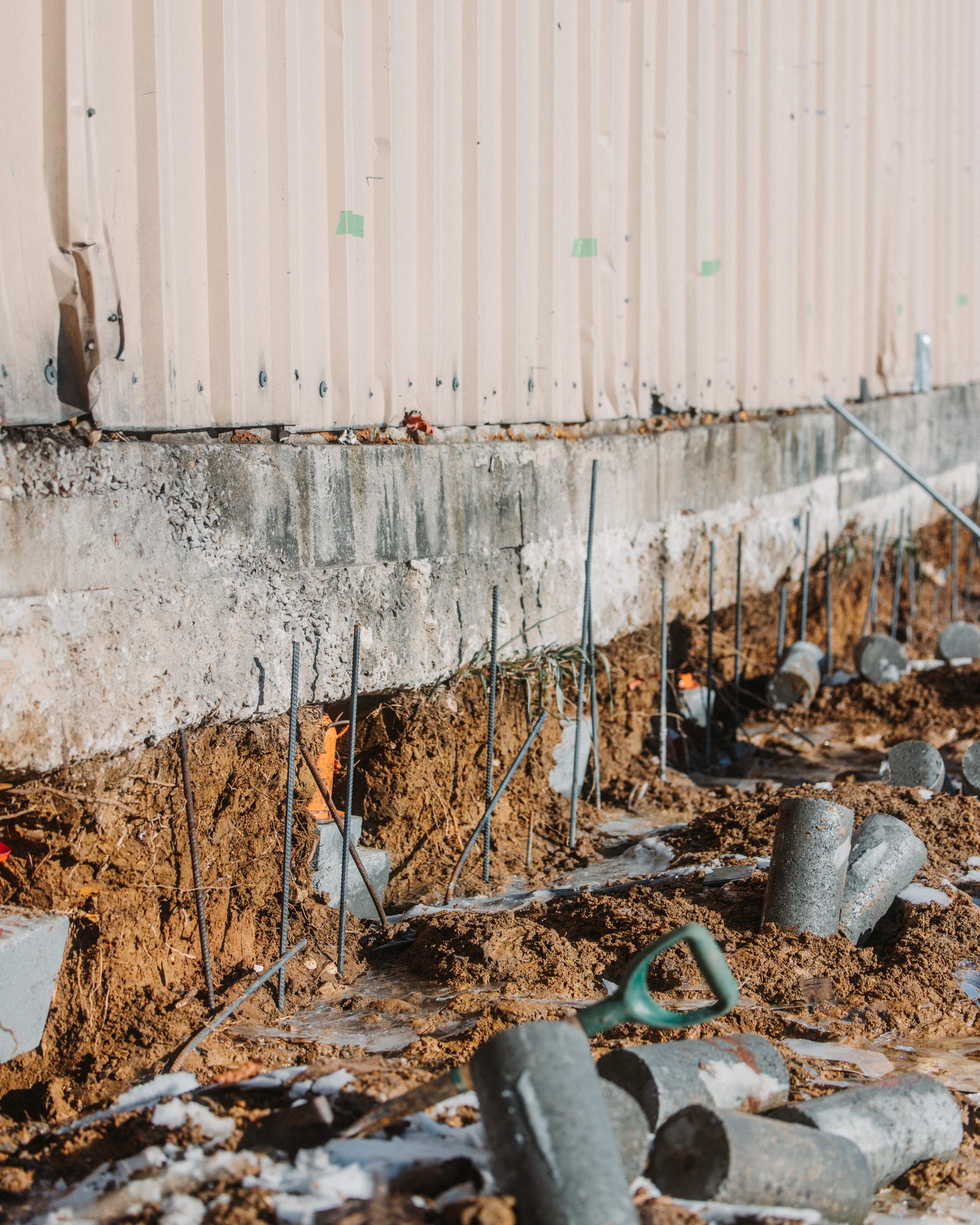 Warehouse concrete piers staged, Imperial Foundation Repair job site in North Texas