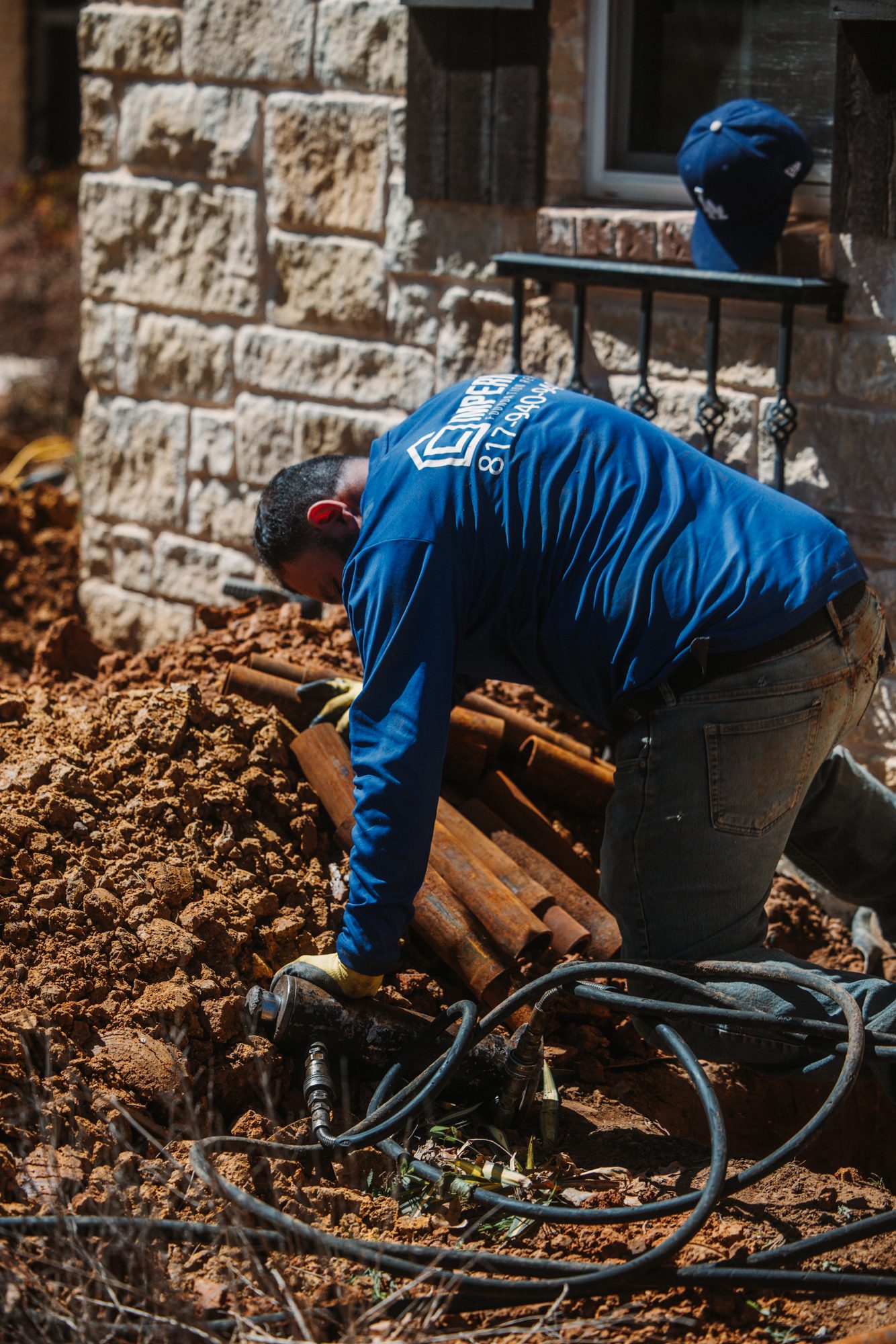 Steel piers staged in dirt, Imperial Foundation Repair job site in North Texas