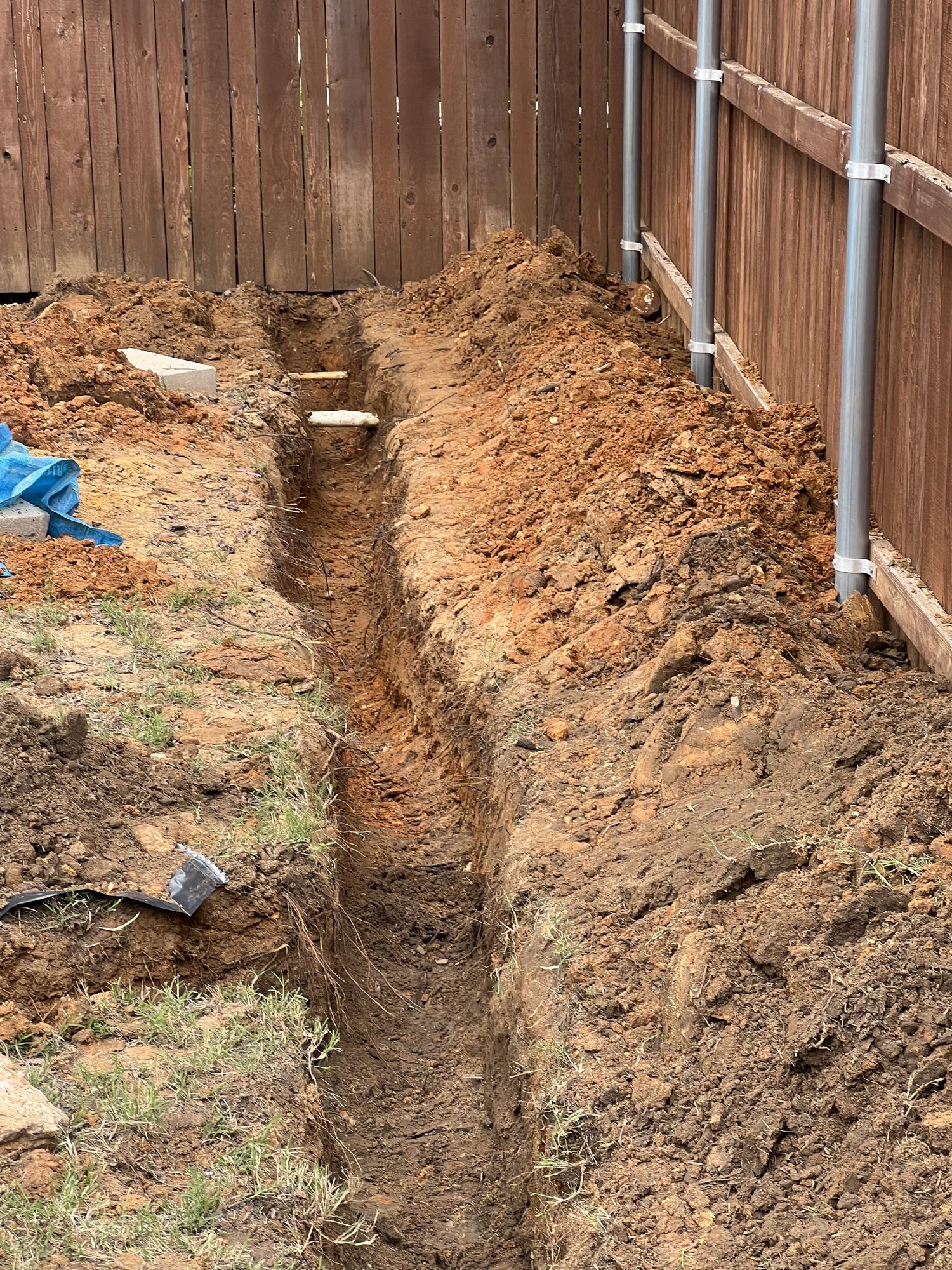 Drain trench along fence, Imperial Foundation Repair job site in North Texas