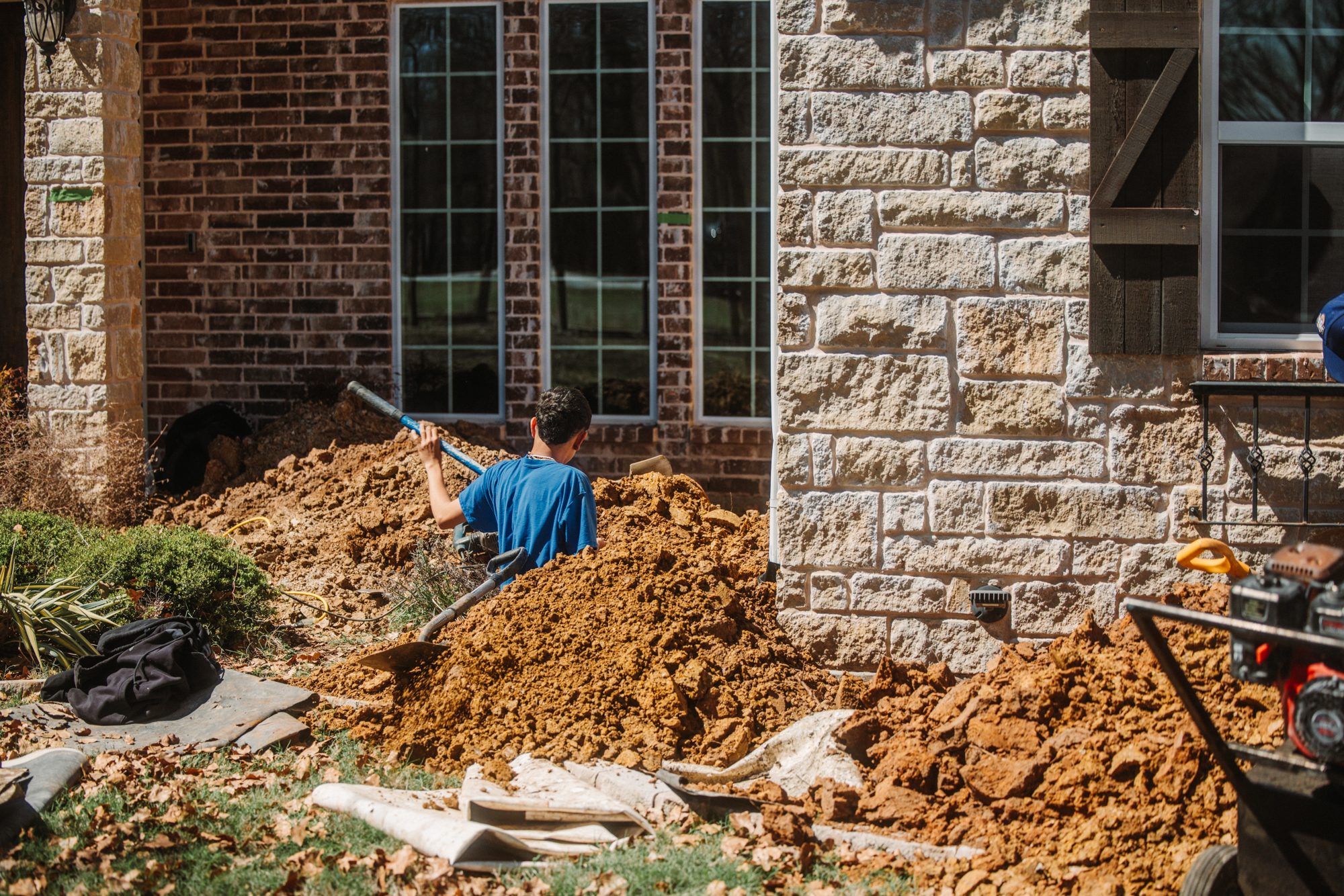 Excavation stone house, Imperial Foundation Repair job site in North Texas