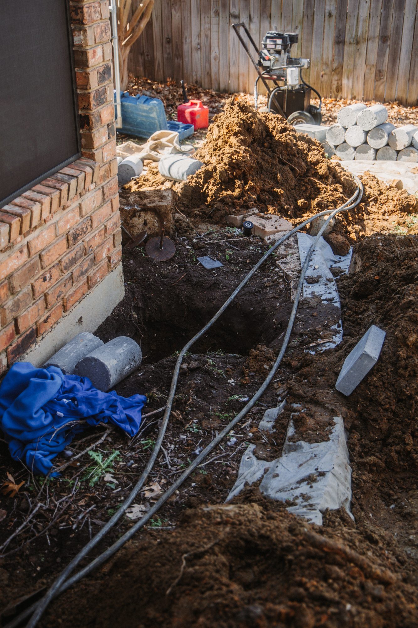 Concrete piers staged in excavation, Imperial Foundation Repair job site in North Texas
