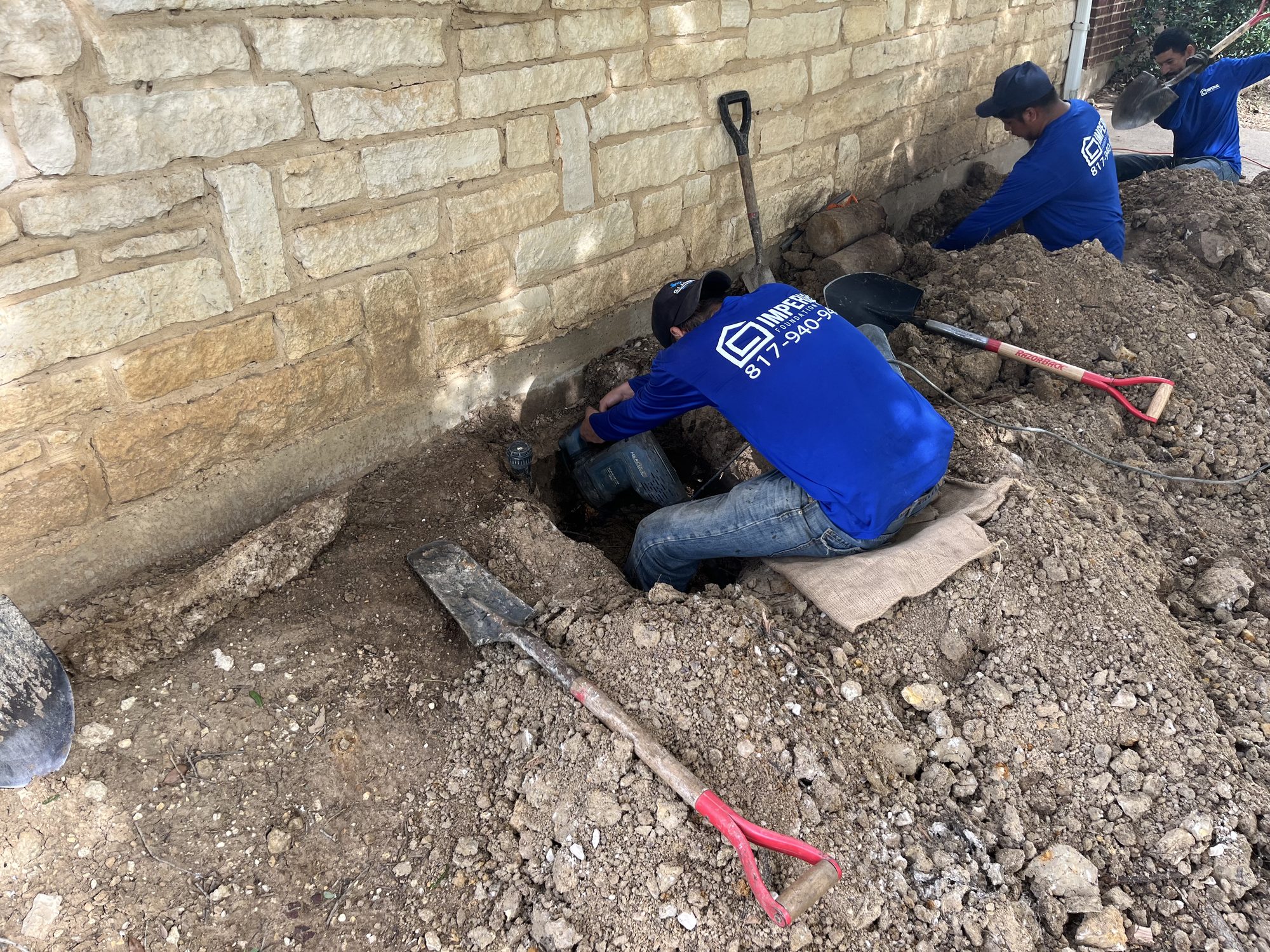 Crew excavation limestone, Imperial Foundation Repair job site in North Texas