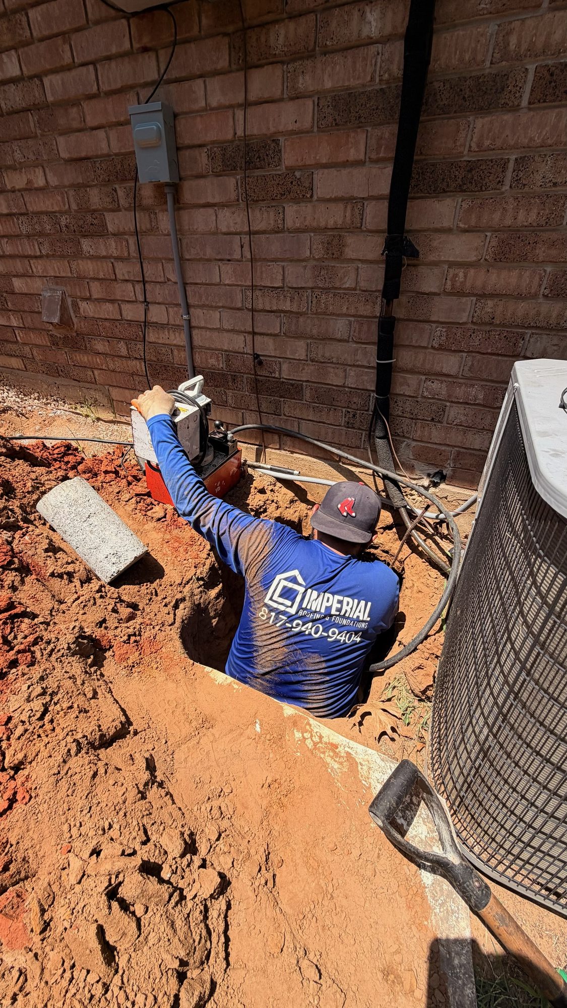 Tunnel dig branded crew, Imperial Foundation Repair job site in North Texas