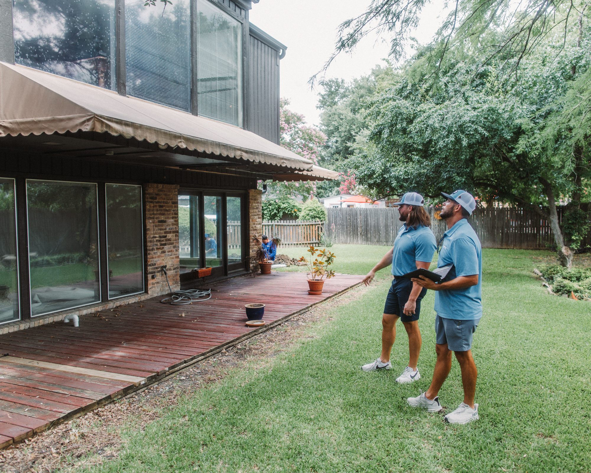 Rep and homeowner backyard, Imperial Foundation Repair job site in North Texas