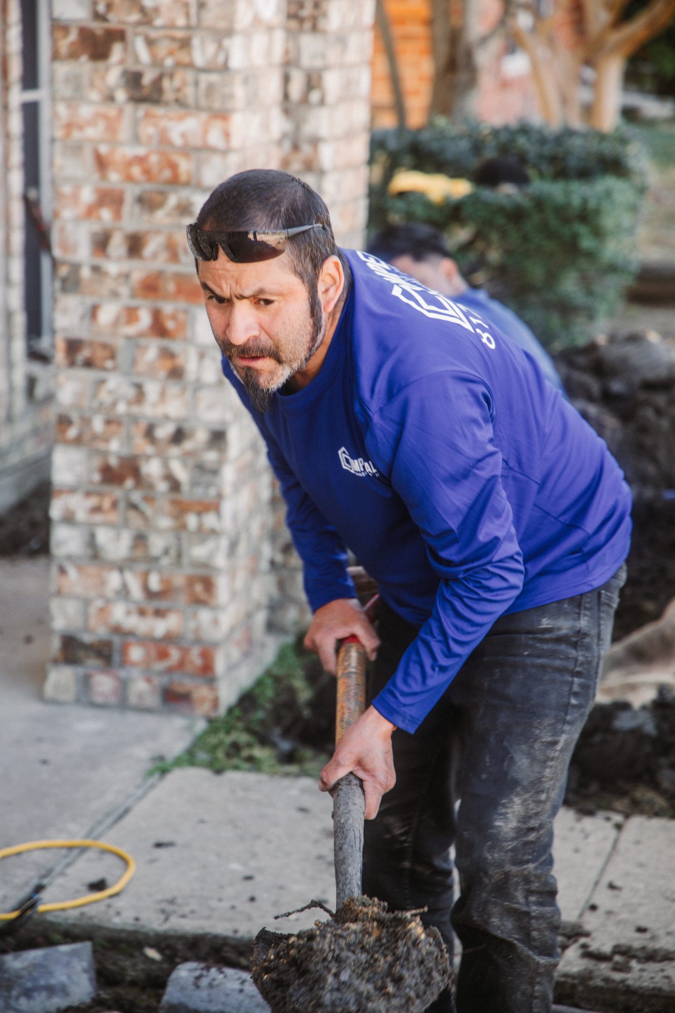 Crew shoveling action, Imperial Foundation Repair job site in North Texas