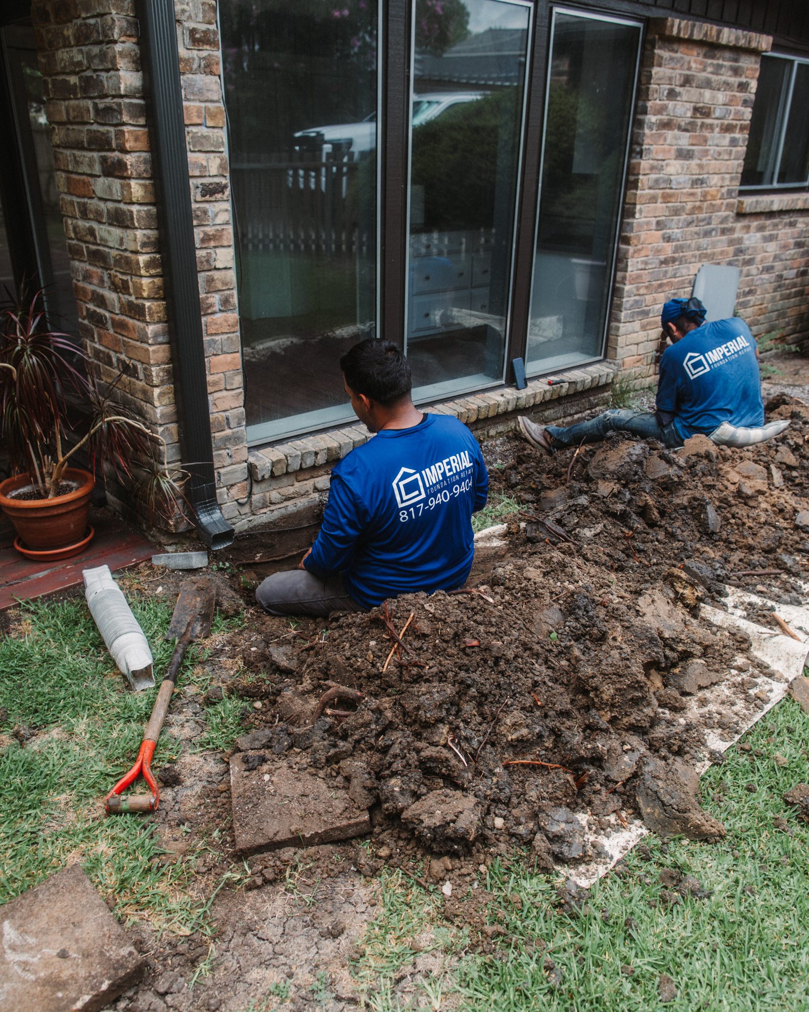 Crew tunneling at windows, Imperial Foundation Repair job site in North Texas