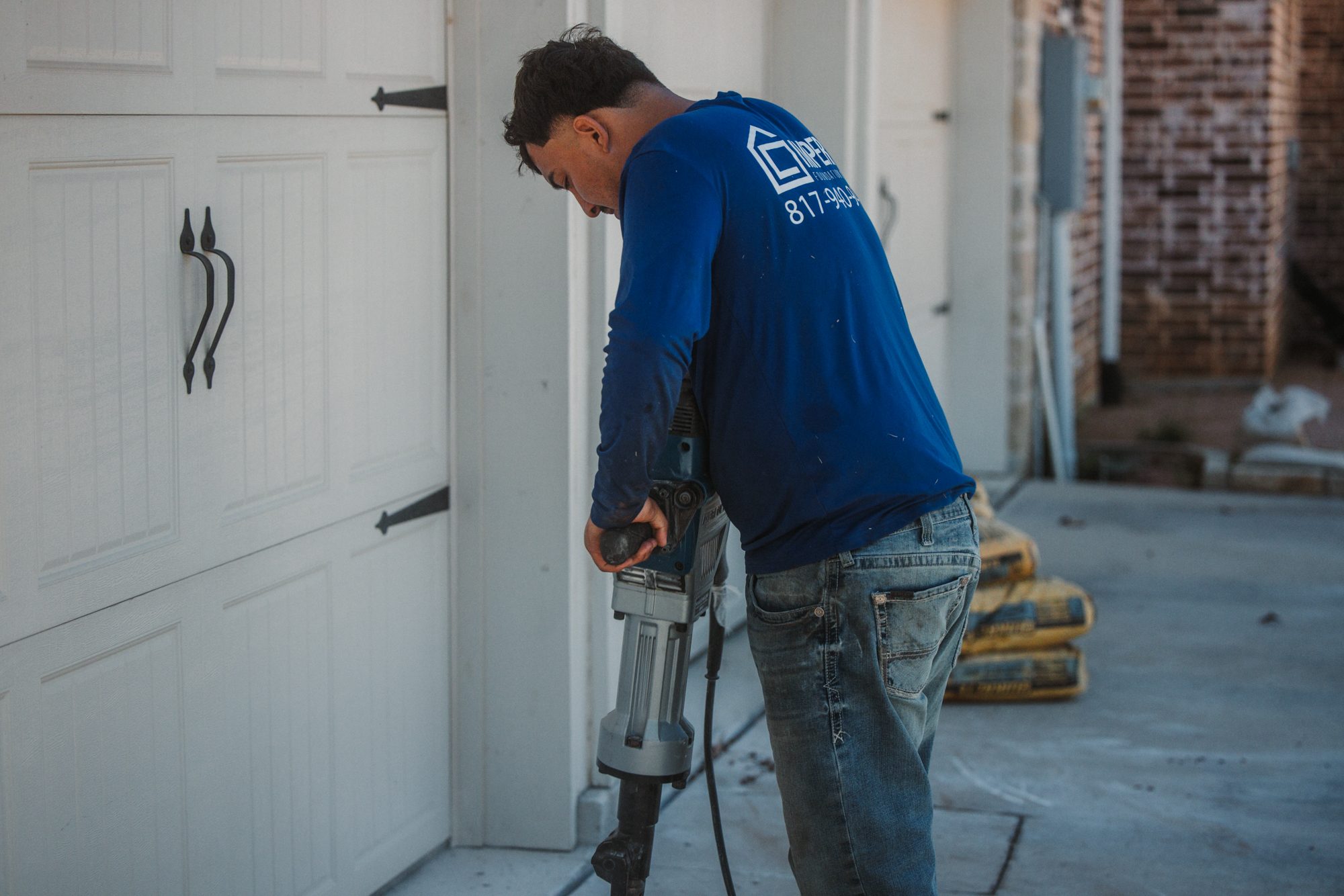 Jackhammer garage door, Imperial Foundation Repair job site in North Texas