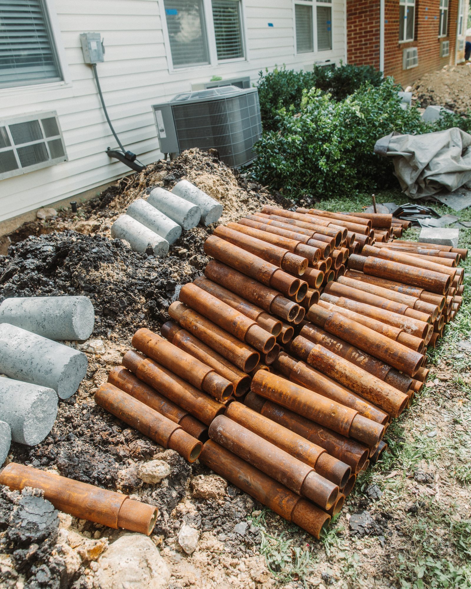 Steel piers and concrete staged, Imperial Foundation Repair job site in North Texas