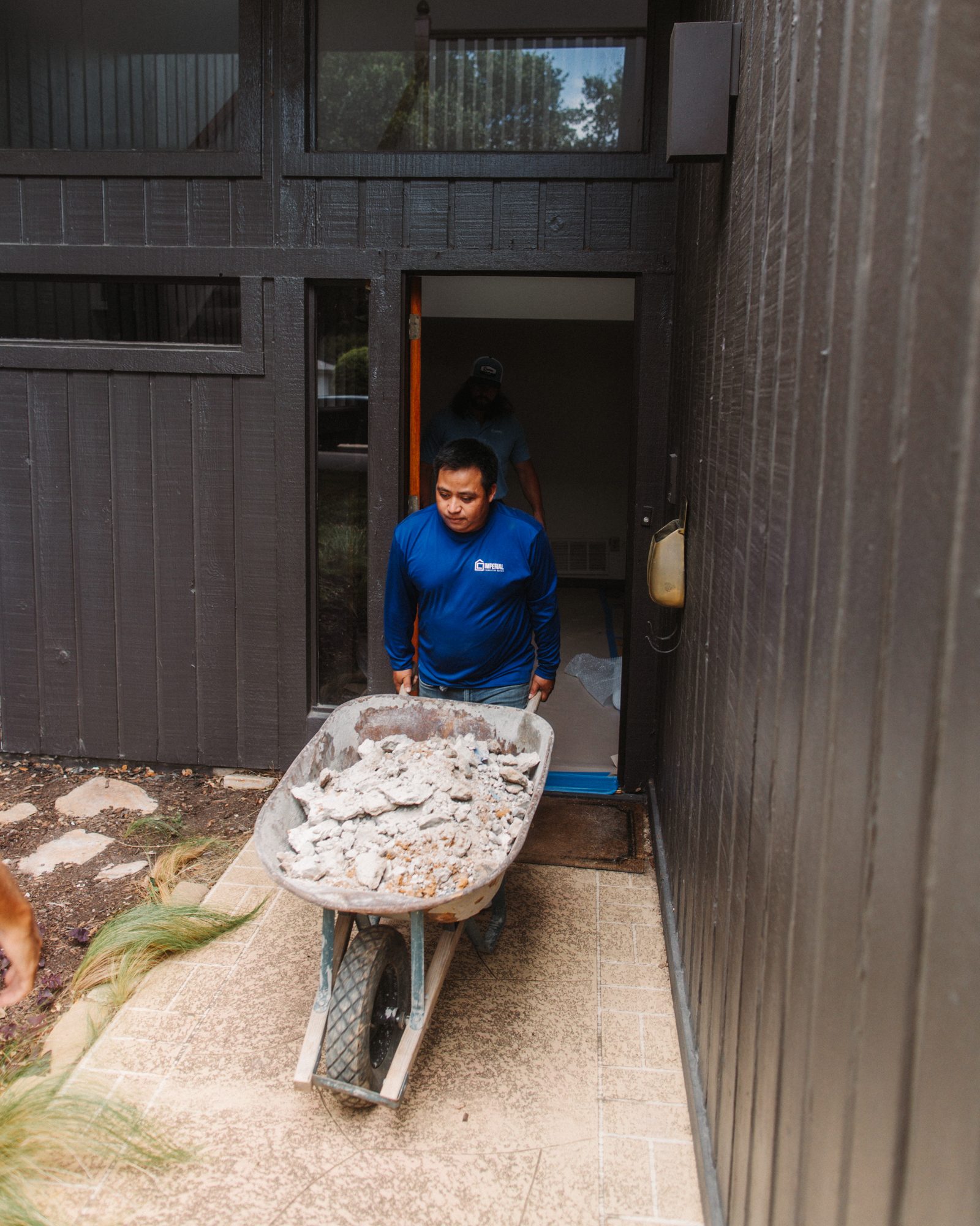 Concrete debris wheelbarrow, Imperial Foundation Repair job site in North Texas