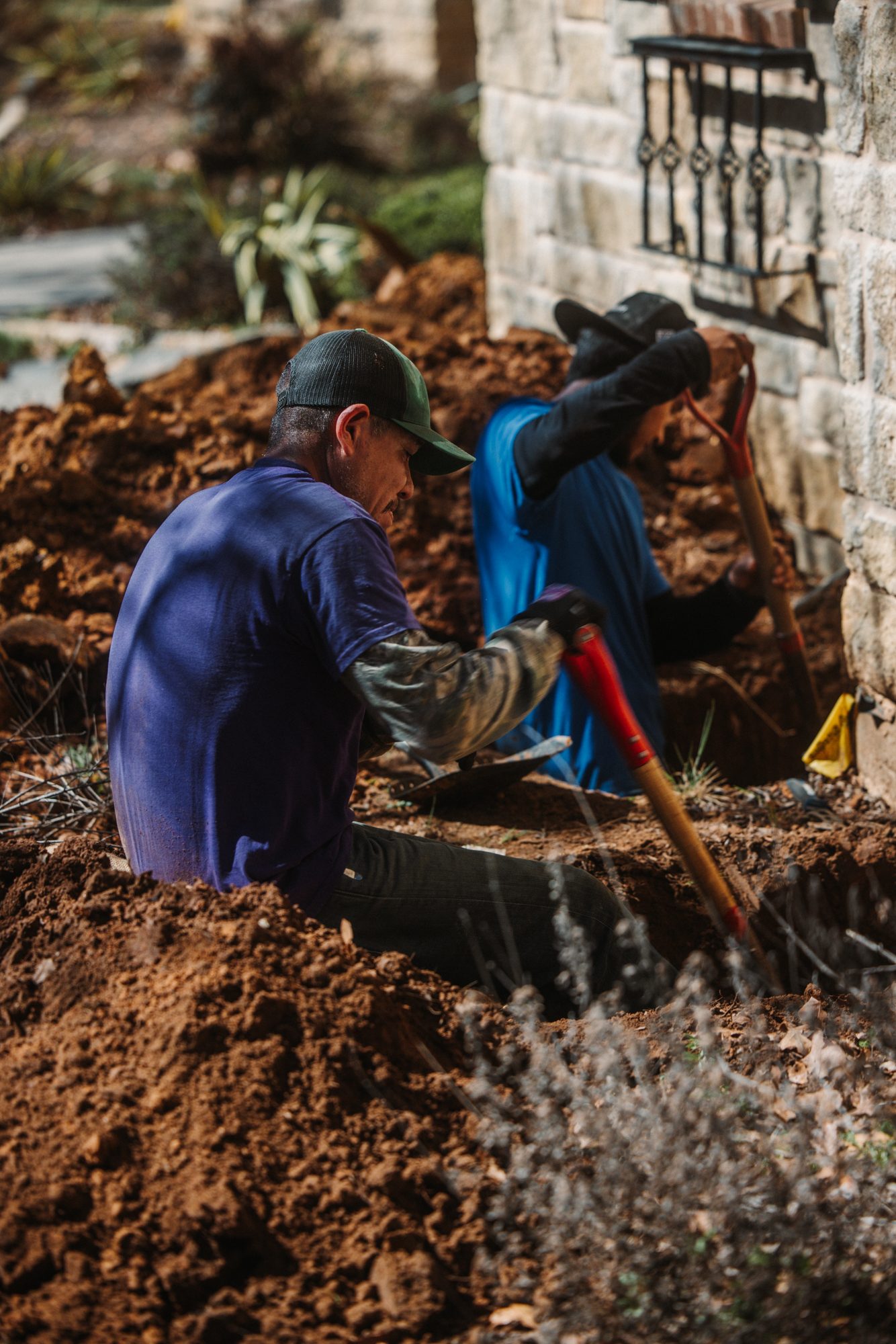 Crew digging two workers, Imperial Foundation Repair job site in North Texas